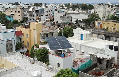 A neighbourhood in Puducherry with a rooftop with installed solar panels