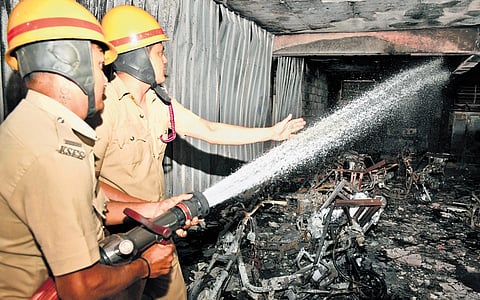 Firefighters try to douse fire gutted inside a godown in Bengaluru on Thursday
