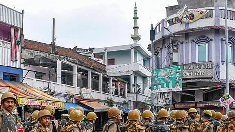 Police personnel stand guard patrol a sensitive area during Friday prayers, a week after violence in Bareilly, in Prayagraj, Friday, Oct. 3, 2025.