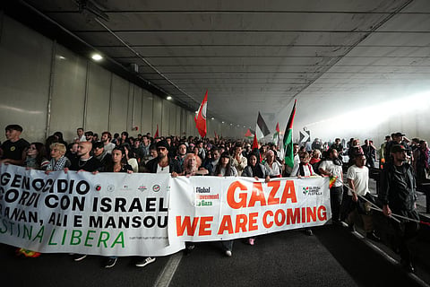 Pro-Palestinian demonstrators march along the Rome’s ring road as they gather for a national general strike called by different unions to protest against the situation in Gaza two days after Israeli forces intercepted a Gaza-bound aid flotilla in the Mediterranean Sea, in Rome, on Friday, Oct. 3, 2025.