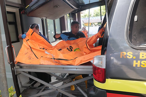 Rescuers remove the newly-recovered body of a victim of a building that collapsed at an Islamic boarding school from an ambulance upon arrival at the police hospital in Surabaya, East Java, Indonesia, Sunday, Oct. 5, 2025.