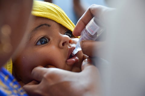 Health workers administer polio drops to children at a vaccination camp held at Tirunelveli New Bus Stand
