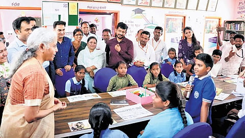 Union Finance Minister Niramala Sitharaman interacts with children in Bagewadi village during her visit to Ballari district on Thursday