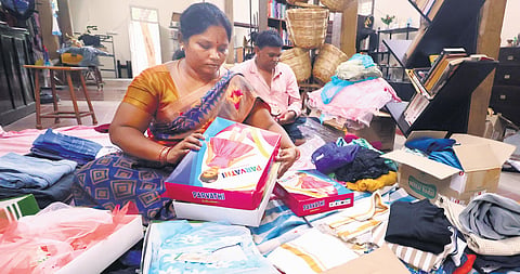 Kalpataru members segregate cardboard boxes and old clothes at the centre.