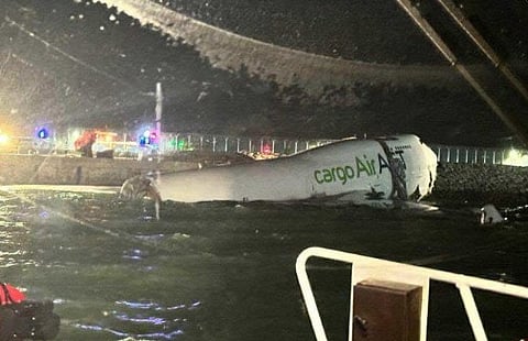 Local Hong Kong broadcasters showed the aircraft partially submerged just off the edge of the airport's sea wall.
