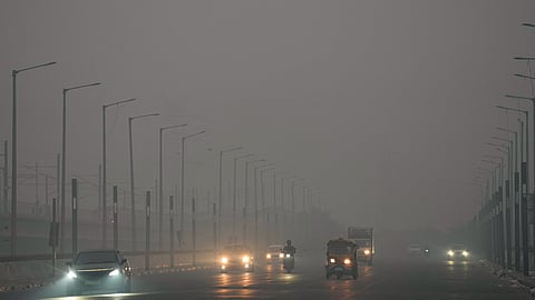 Commuters make their way amid low visibility as air quality deteriorates across Delhi-NCR, Tuesday, Oct. 21, 2025.