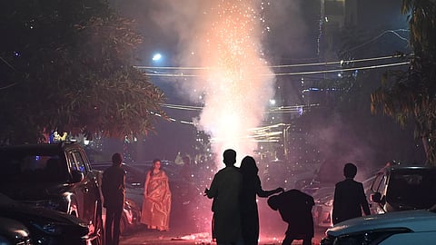 People burst fire crackers on the occasion of Diwali in Delhi NCR on Monday.