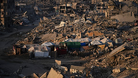 Tents for displaced Palestinians stand amid the destruction caused by the Israeli air and ground offensive in the Sheikh Radwan neighborhood in Gaza City, Wednesday, Oct. 22, 2025.