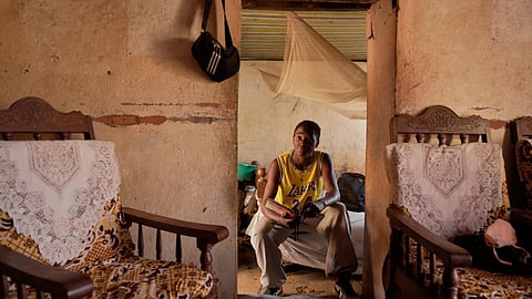 Donah Falia, a 20-year-old student pursuing an accounting course at ABC College, sits inside his aunt's house in the Anosimahavelona informal settlement in Antananarivo, Madagascar, Thursday, Oct. 16, 2025.