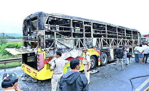 Police personnel investigate the spot after a Hyderabad-bound private bus caught fire following a collision with a two-wheeler, near Chinnatekur in Kurnool district, Andhra Pradesh, Friday, Oct. 24, 2025.