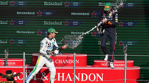 McLaren driver Lando Norris of Britain celebrates on the podium with Red Bull driver Max Verstappen of the Netherlands after wining the Formula One Mexico Grand Prix in Mexico City, Sunday, Oct. 26, 2025.