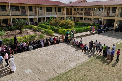 People wait to cast their votes during the general elections at Mpendaye polling station in Zanzibar, Tanzania, Wednesday, Oct. 29, 2025.