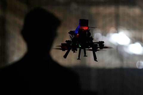Colin Balfour, a sophomore studying robotics engineering, flies a small drone at a simulated night flight at a laboratory at the Worcester Polytechnic Institute, Monday, Oct. 20, 2025, in Worcester, Mass.
