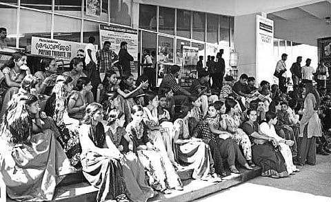 Students from Government Higher Secondary School at Elampachi Kasargod waiting for the afternoon show at Kairali Theatre. A scene from 2009 IFFK.