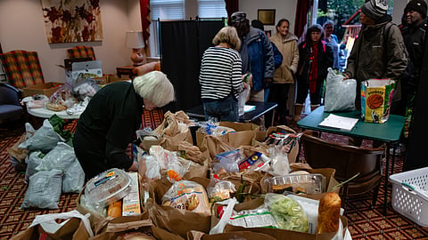 Volunteers work to package meals during the food pantry service at Calvary Episcopal Church on Oct. 30, 2025, in Louisville, Ky.