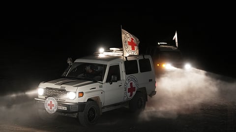 Red Cross vehicles carrying the bodies of three people believed to be deceased hostages handed over by Hamas make their way toward the border crossing with Israel, to be transferred to Israeli authorities, in Deir al-Balah, central Gaza Strip, Sunday, Nov. 2, 2025.