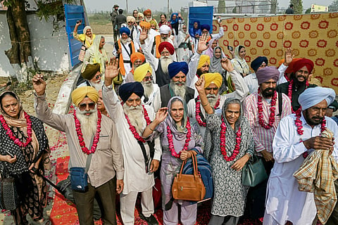 Indian Sikh pilgrims gesture upon their arrival in Pakistan after crossing the India-Pakistan Wagah border in Wagah on November 4, 2025.