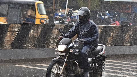 People struggling through heavy rain in Chennai.