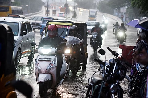 Motorists drive through heavy rain at purasaiwalkam in Chennai.