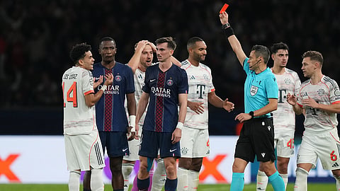 Referee Maurizio Mariani shows the red card to Bayern's Luis Diaz during the Champions League opening phase soccer match between Paris Saint-Germain and Bayern Munich in Paris, France, Tuesday, Nov. 4, 2025.