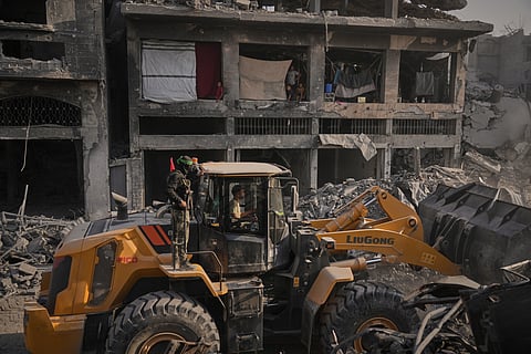 Hamas militants and Egyptian workers search for the bodies of Israeli hostages in the Shijaiyah neighborhood of Gaza City Wednesday, Nov. 5, 2025.