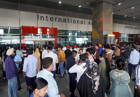 People wait outside the arrivals exit at the Indira Gandhi International (IGI) Airport, in New Delhi, in New Delhi, on Friday.
