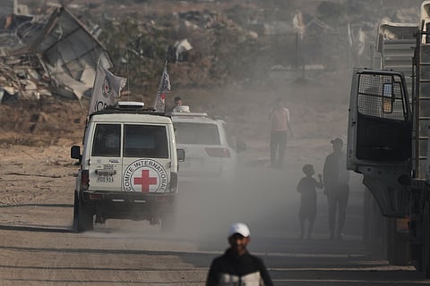 Red Cross convoy carrying what Hamas claims is the remains of an Israeli soldier who was killed in Gaza in 2014 and whose body has been held in Gaza since. makes its way toward the border crossing with Israel, to be transferred to Israeli authorities, in Deir al-Balah, Gaza Strip, Sunday, Nov. 9, 2025.