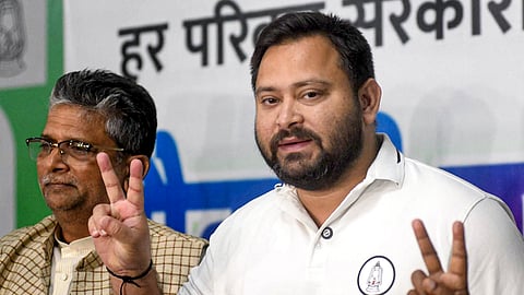 RJD leader Tejashwi Yadav flashes victory sign during a press conference after the conclusion of the Bihar Assembly election, in Patna, Wednesday, Nov. 12, 2025.