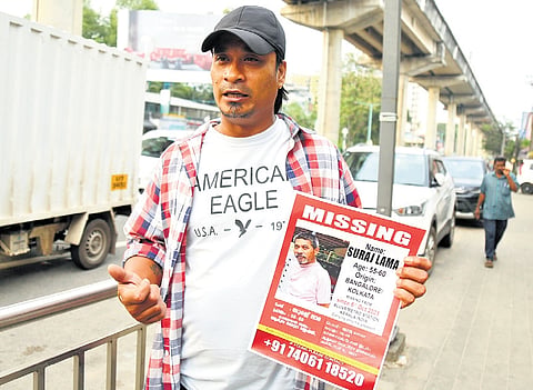 With a poster of his missing father Suraj Lama near the Pathadipalam metro station