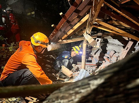 In this undated photo released by the Indonesian National Search and Rescue Agency (BASARNAS) on Friday, Nov. 14, 2025, rescuers search for survivors after a landslide on Thursday, Nov. 13 hit a village in Cilacap, Indonesia.