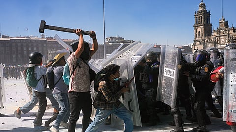 Protesters charge at police during a youth anti-government march in Mexico City, Saturday, Nov. 15, 2025