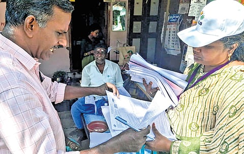 Officials distributing enumeration forms as part of SIR in Mettupalayam