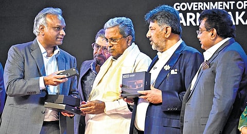 Chief Minister Siddaramaiah, DCM DK Shivakumar, Industries Minister MB Patil and IT-BT Minister Priyank Kharge during the launch of KEO — a compact personal computer — at the Bengaluru Tech Summit on Tuesday