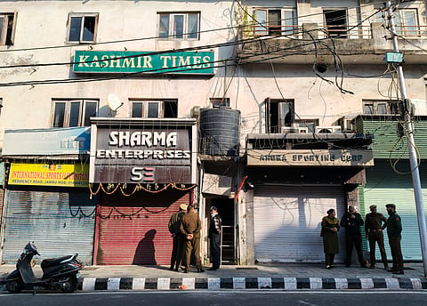Officials outside the Kashmir Times office during a raid by State Investigation Agency (SIA) as part of an ongoing probe into a terror module case, in Jammu, Thursday, Nov. 20, 2025.