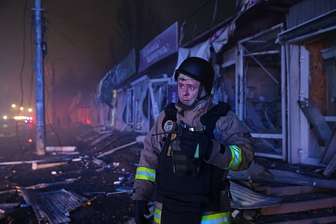 A rescuer works at a market destroyed by a Russian airstrike on Zaporizhzhia, Ukraine, Friday, Nov. 21, 2025.