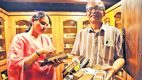 Hari C T, administrator of Sevadhi Museum and Indological Research Institute, and manuscript keeper Remya Bhaskaran with the manuscripts in the museum, located on the Kumaranalloor temple premises