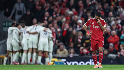 Liverpool's Egyptian striker #11 Mohamed Salah (R) reacts as Nottingham Forrest players (back L) celebrate after their third goal during the English Premier League football match between Liverpool and Nottingham Forest at Anfield in Liverpool, north west England on November 22, 2025.