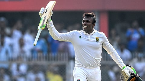 South Africa's Senuran Muthusamy celebrates after scoring a century (100 runs) during the second day of the second Test cricket match between India and South Africa at the Barsapara Cricket Stadium in Guwahati on November 23, 2025.