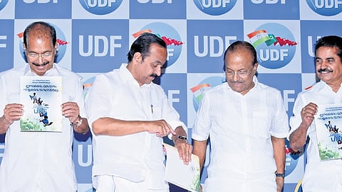 As Sunny Joseph and Adoor Prakash pose with a copy of the UDF manifesto,
V D Satheesan points at his watch indicating to P K Kunhalikutty that it was time to leave for the next event, in Kochi on Monday