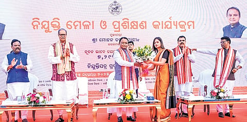 Chief Minister Mohan Charan Majhi handing over appointment letter to a newly- recruited candidate, in Bhubaneswar on Tuesday