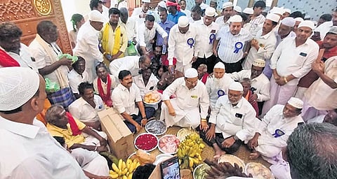 Hindu residents arrive with offerings to greet the Muslim community during the inauguration of the renovated town Mosque in Annavasal on Friday