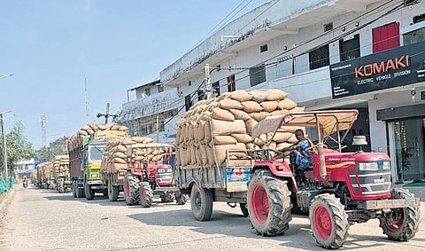 Farmers waiting outside Bareipali RMC in Sambalpur with their paddy.