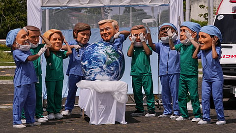 Demonstrators with the likeness of world leaders including President Donald Trump, center, pretend to drill into the Earth during the COP30 U.N. Climate Summit, Thursday, Nov. 20, 2025, in Belem, Brazil.