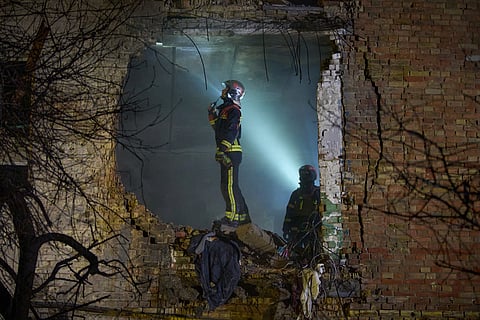 Rescuers search for victims after a drone hit a residential building during Russia's night missile and drone attack in Kyiv.