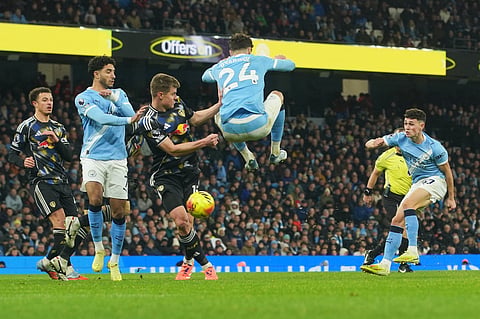 Manchester City's Phil Foden, right, scores during the English Premier League soccer match between Manchester City and Leeds United in Manchester, England, Saturday, Nov. 29, 2025.