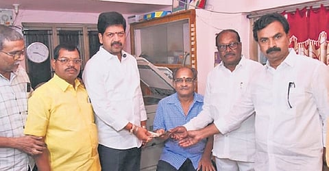 Excise minister Kollu Ravindra handovers pension to the beneficiaries on Monday.