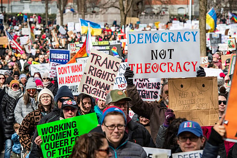 Demonstrators rally on Boston Common on International Women's Day in Boston, Massachusetts, on March 8, 2025.