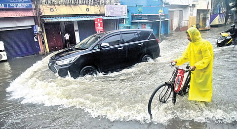 Road users manoeuvre a flooded Stephenson Road in Vyasarpadi amid rain on Wednesday