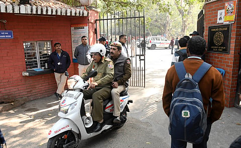 Delhi police personnel, college staff and students at Ramjas college in Delhi University after receiving bomb threat emails in New Delhi