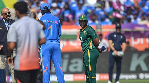 South Africa's captain Temba Bavuma (R) stands during the toss as his Indian counterpart KL Rahul (2R) speaks with commentator Murali Kartik (L) before the start of the third one-day international (ODI) cricket match between India and South Africa at the Y.S. Rajasekhara Reddy Cricket Stadium in Visakhapatnam on December 6, 2025.